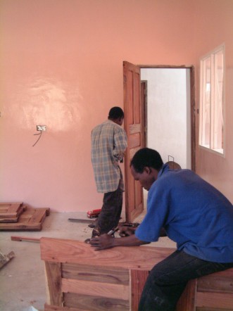 Gilbert Samile makes sure all the doors fit correctly