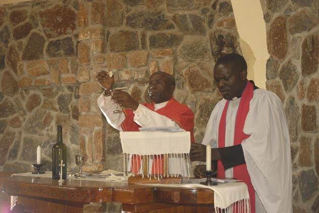 Canon John Madihi celebrates communion in St. Luke's Chapel